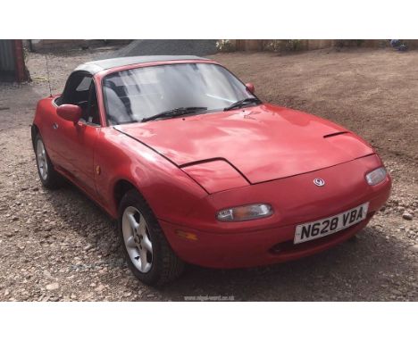 A Mazda MX5 sports car, registration no. N628 VBA, two door, finished in red, petrol, first registered August 1995, 1839 cc c