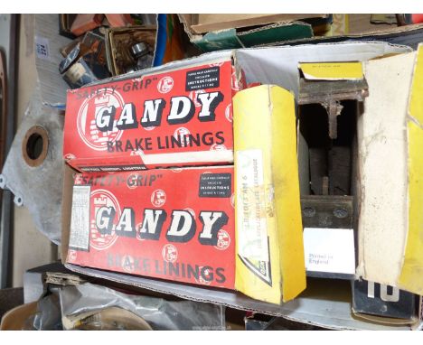 A box of vintage brake linings and brake shoes (used).