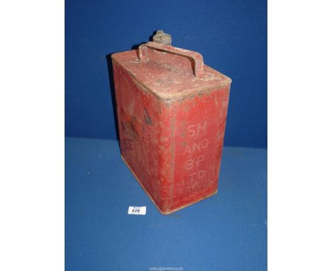 A vintage red metal SM & BP Ltd petrol can.