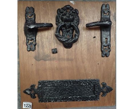 Victorian style metal door fixings to include handles, knocker, letter box, all mounted on board. Not available for in-house 