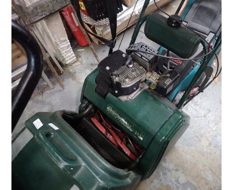 Atco Balmoral 14F Petrol lawn mower with an additional scarifier, working at lotting. Not available for in-house P&amp;P, con