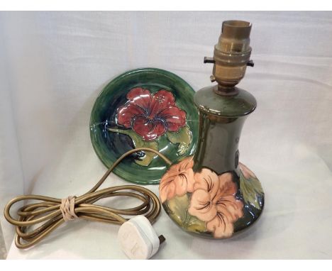 Moorcroft plate with substantial damage and a Moorcroft lamp with restoration to base, H: 25 cm. Not available for in-house P