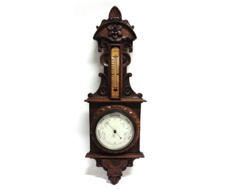A LATE VICTORIAN CARVED OAK FRAMED BAROMETER  with later thermometer, 96cm high