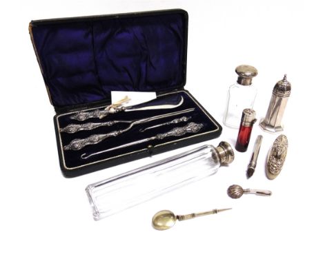 A SILVER PEPPER a silver copy of a Roman spoon; a silver napkin holder; a silver bridge pencil; a scent bottle; two toilet bo