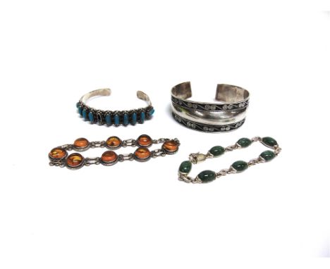 A TURQUOISE SET TORQUE BANGLE  an unmarked bangle; a silver jade set bracelet; and another stone set bangle