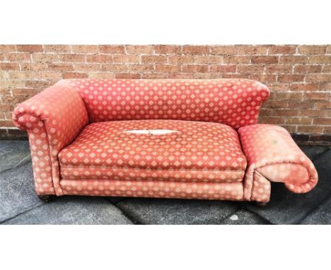 AN EDWARDIAN DROP-END CHESTERFIELD SOFA for restoration, on bun feet with brass casters, 170cm wide