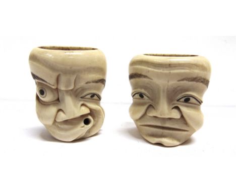 A PAIR OF JAPANESE CARVED BONE OKIMONO NETSUKE  modelled as faces, probably Meiji, each approximately 45mm high