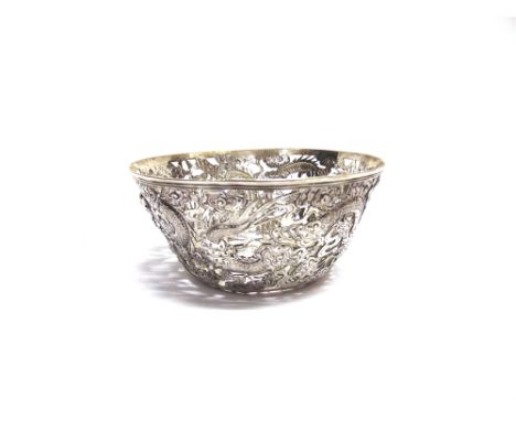 A CHINESE SILVER PIERCED BOWL character mark only, decorated with dragons chasing the flaming pearl, 12.3cm across, 5.5cm hig