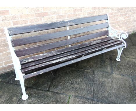 A GARDEN BENCH  the cast iron ends with foliate decoration