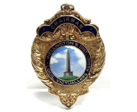 A SILVER GILT AND ENAMEL CHAIRMAN OF WELLINGTON AND DISTRICT LOCAL VICTUALLERS ASSOCIATION BADGE  by A. Frattorini, Birmingha