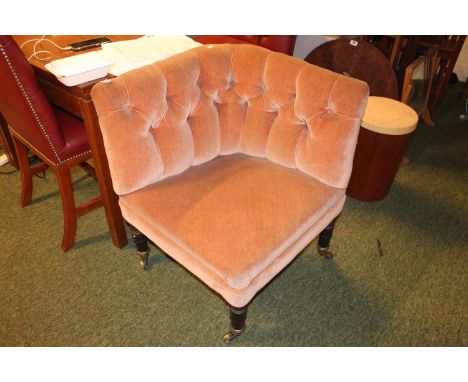 Victorian upholstered button back chair on turned legs and brass casters 