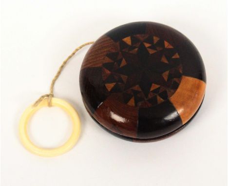A rare Tunbridge ware yo yo, each side with a circular panel of stick ware within borders of variant woods, 6cms dia. &nbsp; 