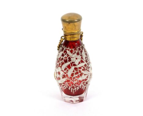 A late 19th Century ruby glass tinted scent bottle, of octagonal section the body overlaid with painted ‘lace’ hinged gilt br