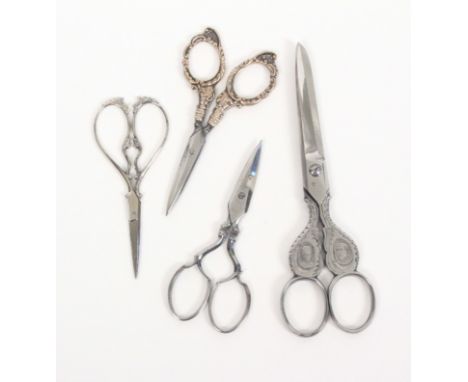 Four pairs of scissors, comprising a pair with steel blades to floral silver arms and loops, 10cm, a good pair of polished st
