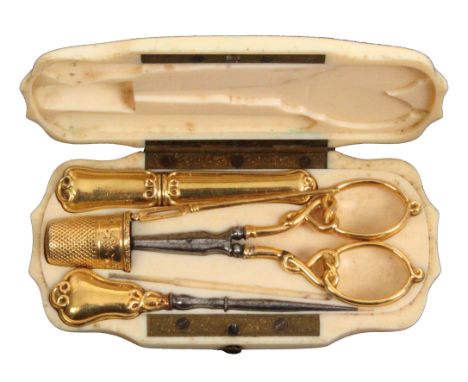 A 19th Century French ivory etui with a full complement of gold fittings, the case of stepped and shaped outline, the flush s