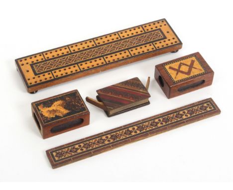 Tunbridge ware – four pieces and another, comprising a geometric mosaic cribbage board, 22.5cms, a geometric mosaic ruler, 23