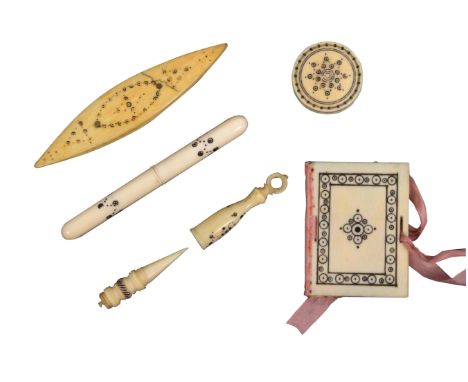 Five 19th Century ivory Madras sewing tools, with burnt circle decoration comprising a needle book, 5cms, a cylinder needle c