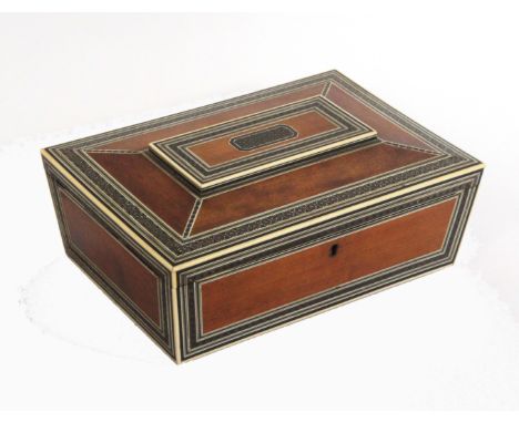 An early 19th Century Anglo Indian sandal wood and Sadeli work sewing box of sarcophagol form, the interior with inset mirror