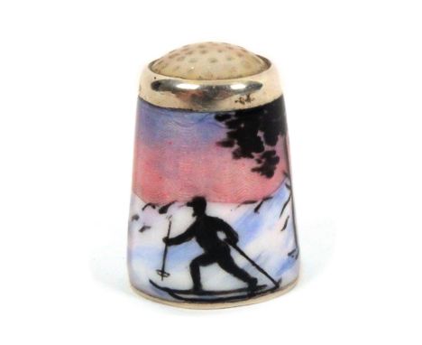 A Norwegian silver and enamel thimble by Askel Holmsen, with a lone skier set against an extensive mountainous winter landsca