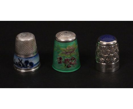 Three 20th Century silver thimbles, comprising a continental example with Delft style enamel frieze, and two others by James 