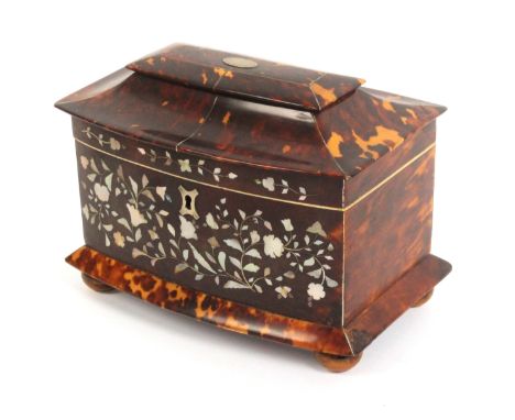 A Victorian bow front tortoiseshell tea caddy, the pagoda style top divided by pewter lines, the front inlaid with sprays of 