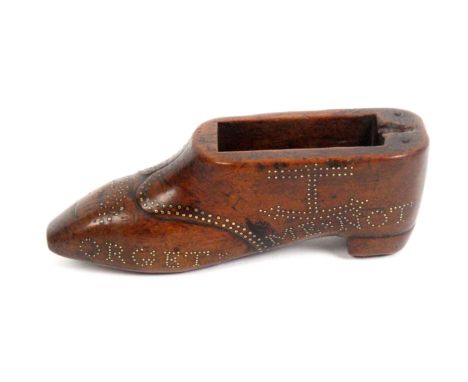 A late 18th Century or early 19th Century elaborately decorated snuff shoe in fruitwood, lacking the swivel lid, inscribed in