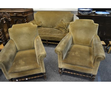 An Edwardian two seater sofa and conforming armchairs, bobbin turned stretcher