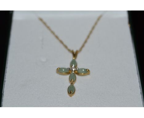 A 9ct gold ladies jade an diamond cross with a fine 9ct gold chain