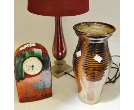 A Poole pottery mantel clock; a ribbed stoneware baluster vase; a contemporary brushed chrome and coloured glass table lamp (