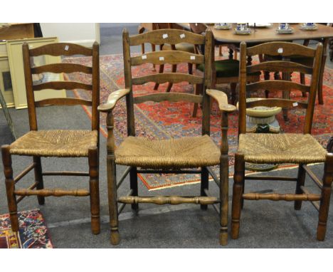 An early to mid 20th century pair of rush seated ladder back chairs, a conforming carver (3)