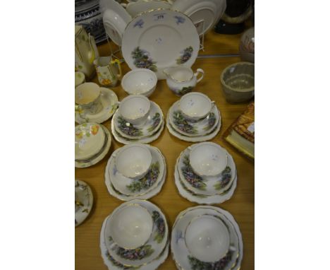 A Royal Vale part tea service printed with a thatched roof cottage, consisting of a bread and butter plate; cream jug, sugar 