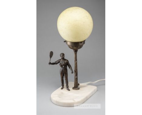 An early tennis lamp, circa 1920,  with spelter tennis figure, stand and marble base, 40 by 22 by 14cm., the glass sphere has