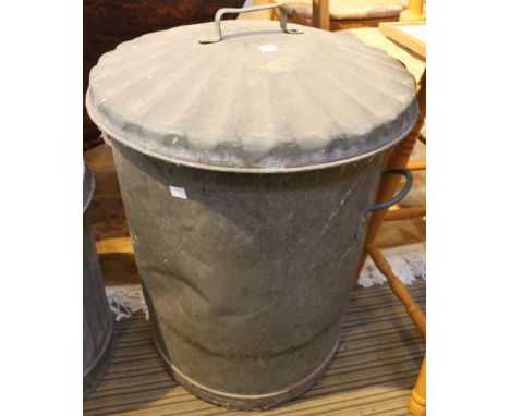 A vintage galvanised dustbin with lid