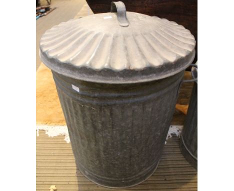 A vintage galvanised dustbin with lid