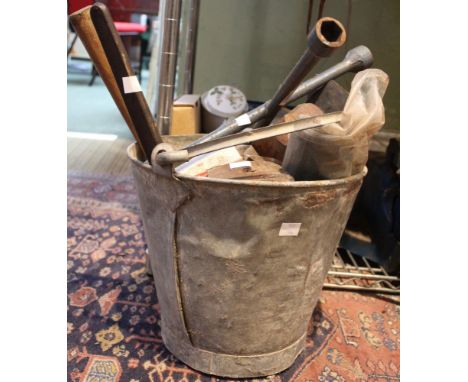 A galvanised bucket containing a quantity of vintage tools