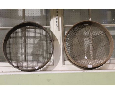A pair of vintage wooden garden sieves