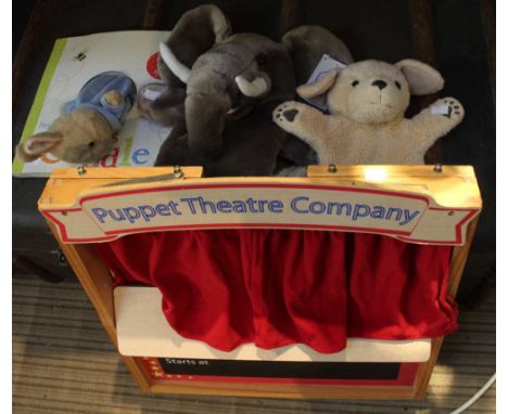 A wooden child's puppet theatre company two hand puppets and a Peter Rabbit book