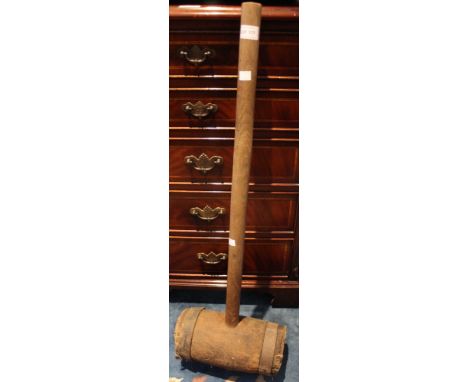A vintage wooden metal bound large mallet