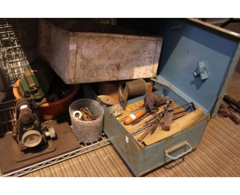 A tin trunk containing a selection of tools oil jug etc