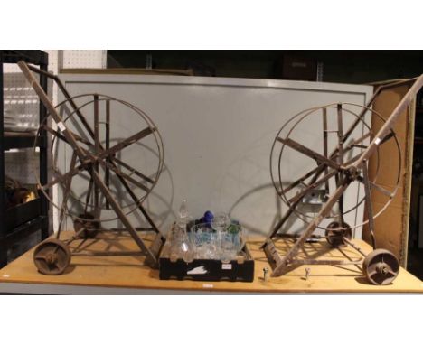 A pair of vintage metal portable garden hose reels
