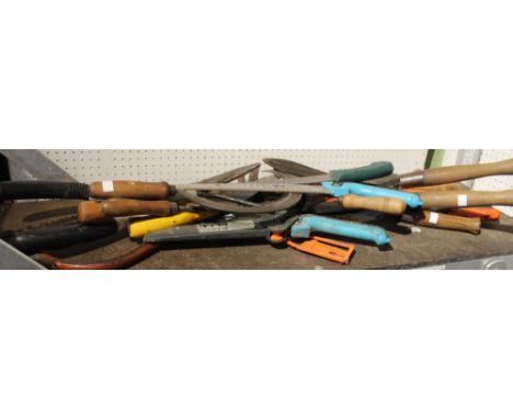 A quantity of garden saws, vintage sickle etc