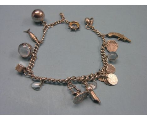 A silver charm bracelet, charms include silver whistle, seal and compass 