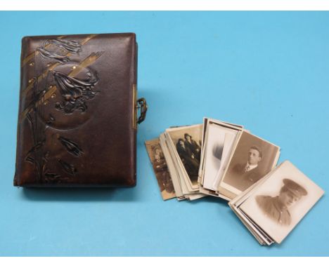 A late Victorian leather photograph album, with sprung brass clasp, some portrait photographs within, and an assortment of lo