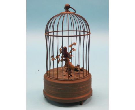 A late 19th century singing bird automaton, in the form of a domed circular bird-cage, two articulated birds within, integral