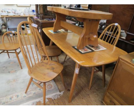 An Ercol golden elm dining suite, six-seater table, set of four stick-back chairs, similar child's chair, sideboard with cupb