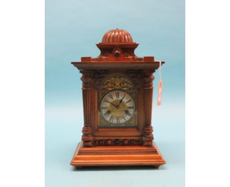 A Victorian walnut bracket clock, architectural form with arched brass dial, German movement, with key and pendulum, 17in. hi
