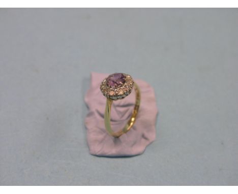 An 18ct. gold diamond and amethyst cluster ring, size N, Birmingham 1965