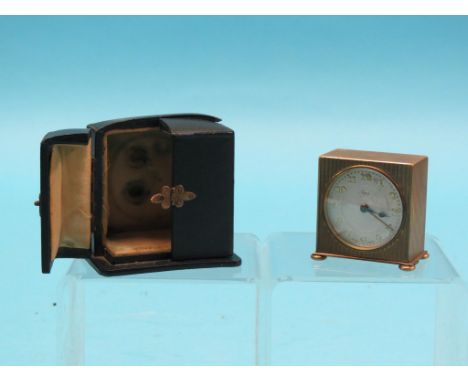 An Asprey gilt-metal travelling alarm clock, engraved case with silvered dial, 2.5in. in original leather case - minute hand 