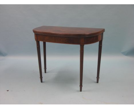 A George III inlaid mahogany card table, D-shape on reeded, tapering legs, 3ft.