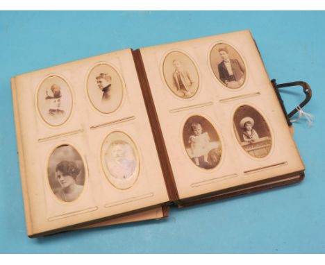 A Victorian family portrait photograph album, binding considerably worn 